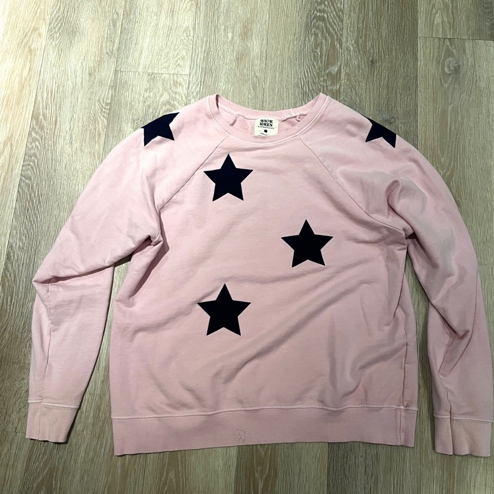 Pink crewneck sweatshirt with star appliqués